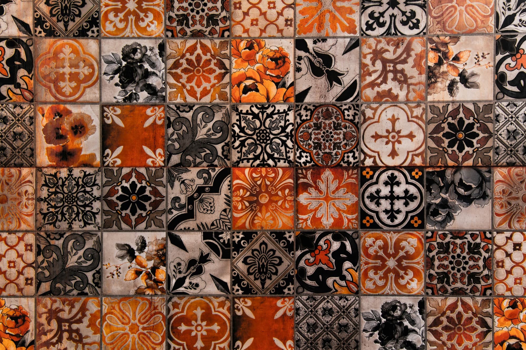 A wall of patterned ceramic tiles, every square carrying a different design